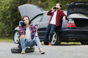 Car breakdown. A woman calling for roadside assistance.