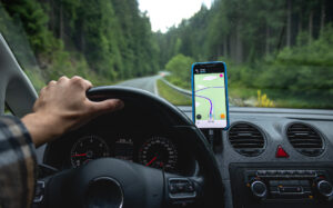Mężczyzna prowadzi samochód z pomocą nawigacji GPS.
