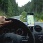A man is driving a car using GPS.