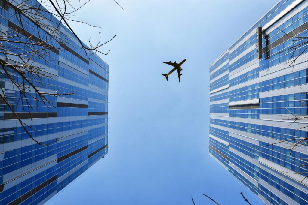 An airplane over skyscrapers
